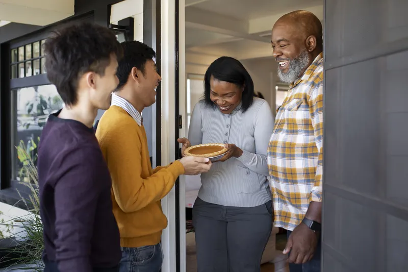 Australian homestay family welcoming an East Asian student at their front door